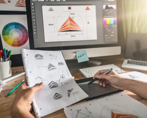 Graphic designer drawing sketches logo design. The concept of a new brand. Professional creative occupation with idea.